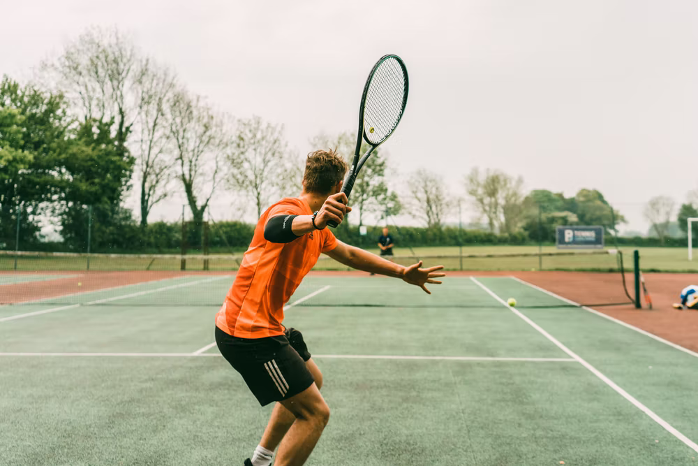 Tennis players playing on a grass court